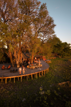 A couple enjoys the view from the deck at Kiri Camp