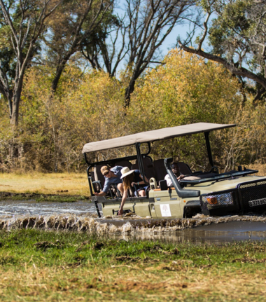 Safari vehicle wading through the waters of the Okavango Delta Safari vehicle wading through the waters of the Okavango Delta