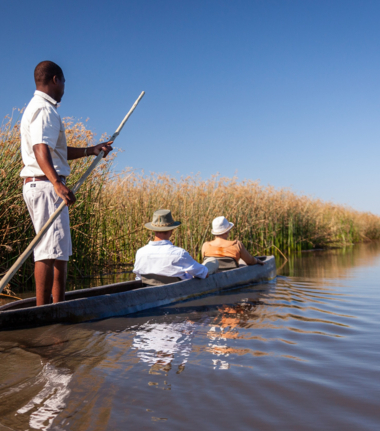 Canoeing down a water system in the Okavango Delta Canoeing down a water system in the Okavango Delta