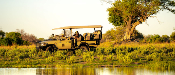 A game drive vehicle searches for wildlife on the Okavango Delta